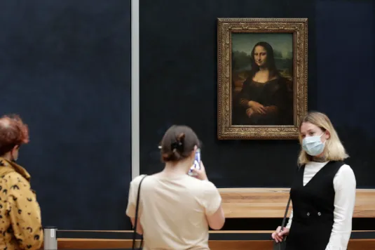 Visitors looking at a painting in a museum